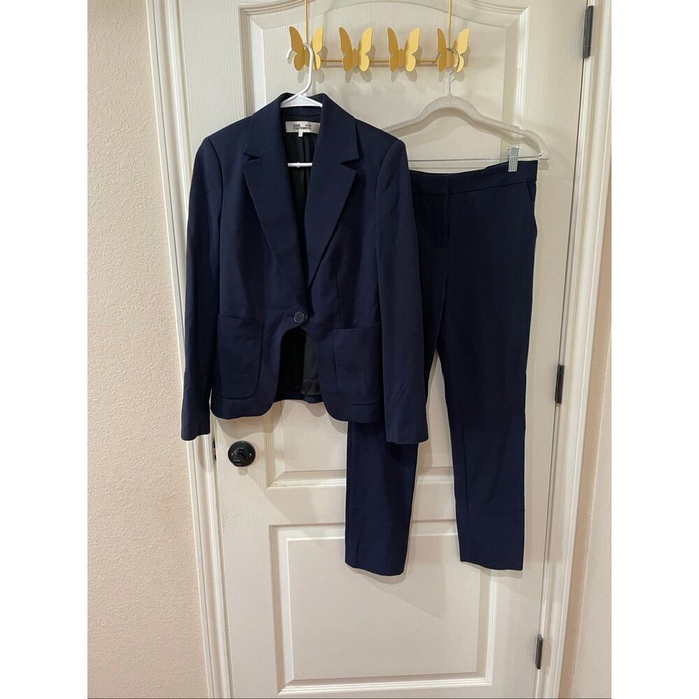 Diane von Furstenberg navy blue suit features a tailored blazer and pant